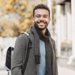 Joyful smiling men in a city. Autumn and winter concept