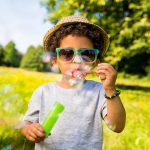 Male child blowing bubbles